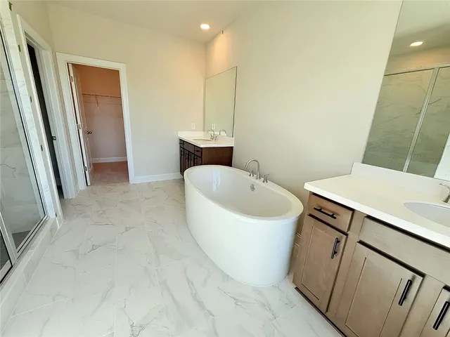 a bathroom with a glass shower door and mirror