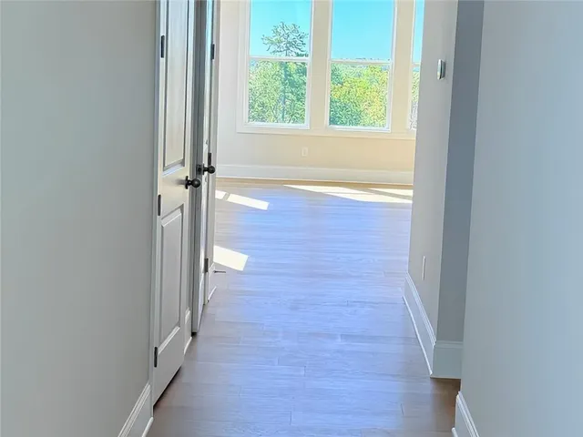 an empty room with windows and closet