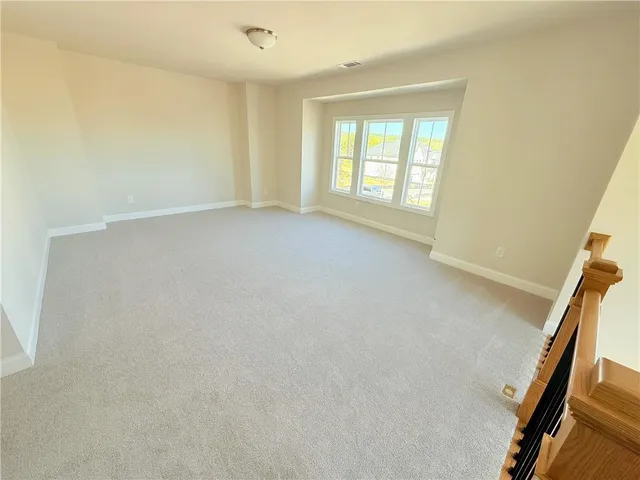 a view of staircase with railing and a window