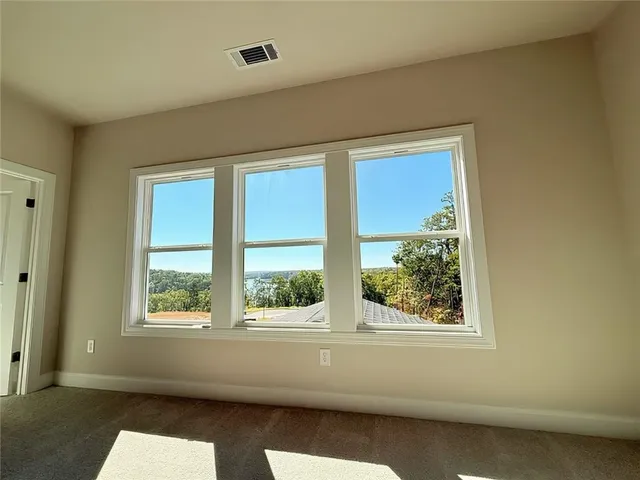 an empty room with a empty space and windows