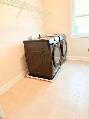 a kitchen with kitchen island a large counter top space appliances and a ceiling fan