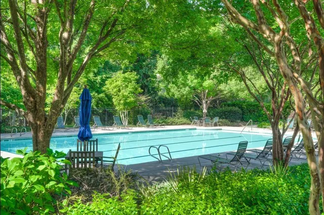a view of a patio with couches table and chairs and potted plants