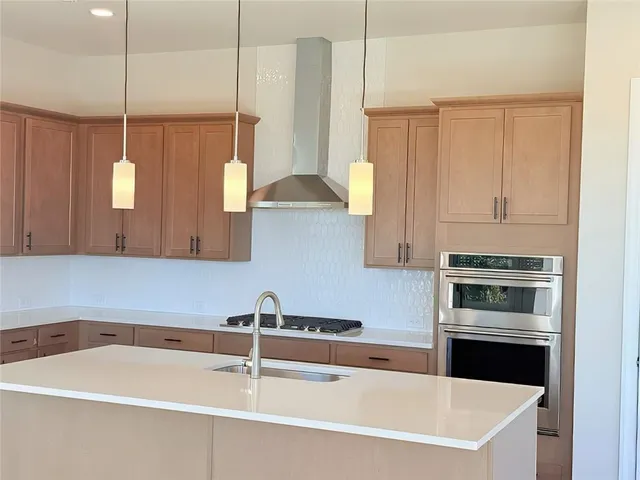 a kitchen with a sink a counter and appliances