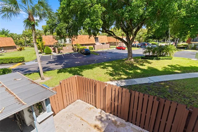 a view of a backyard with wooden fence