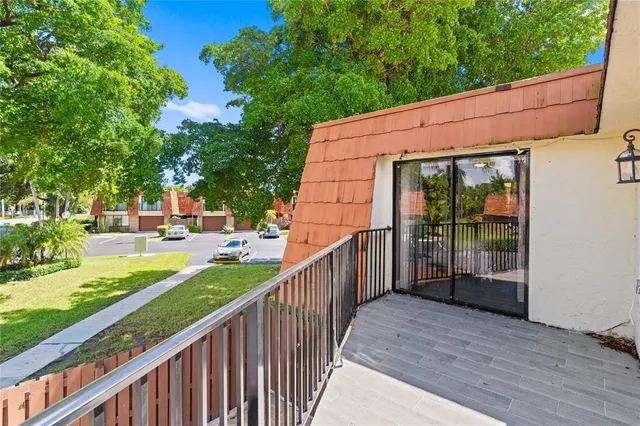 a view of a house with backyard and porch