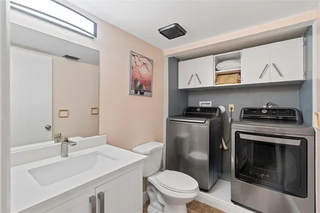 a bathroom with a sink a toilet and a mirror