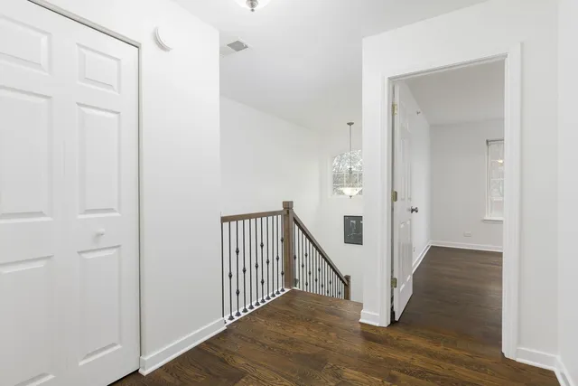 a view of a hallway with wooden floor and entryway