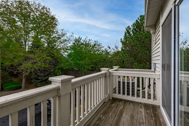 a view of balcony with wooden floor and fence