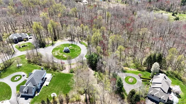 an aerial view of a house with garden space and trees