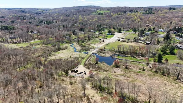 an aerial view of a golf course with street