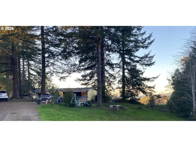 a view of a house with a yard and sitting area