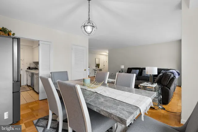 a living room with furniture a flat screen tv and a chandelier