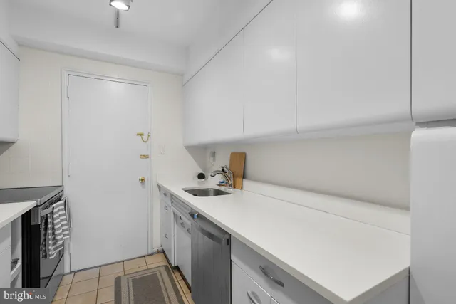 a room with a sink cabinets and utility room