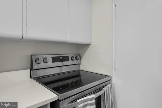a stove top oven sitting inside of a kitchen