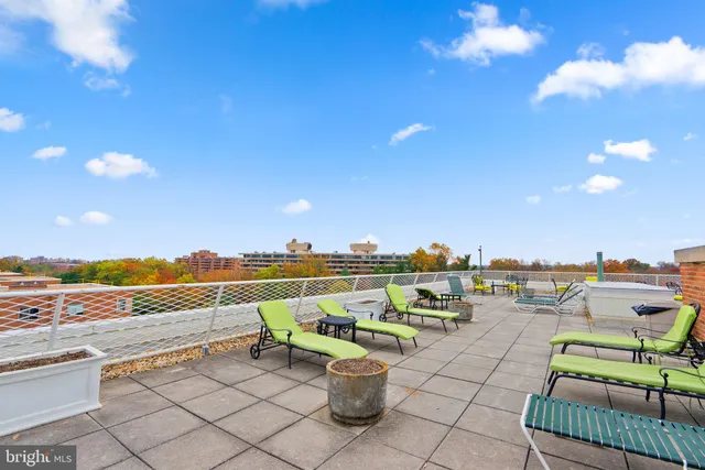 a view of a terrace with lawn chairs