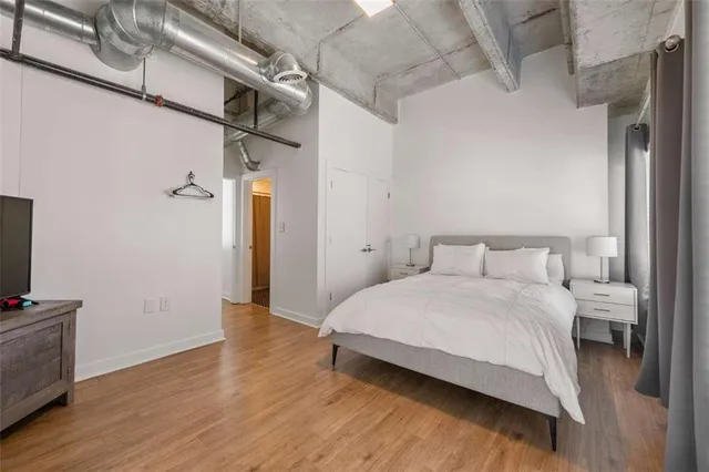 a bedroom with a bed and a large window