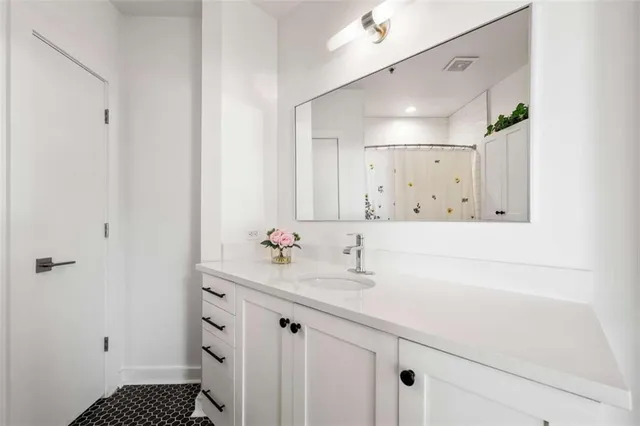 a bathroom with a sink a toilet a shower and a mirror