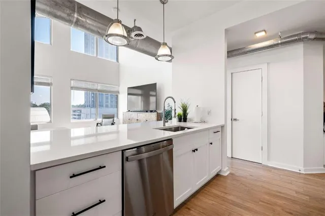 a kitchen with a table a chandelier and living area view