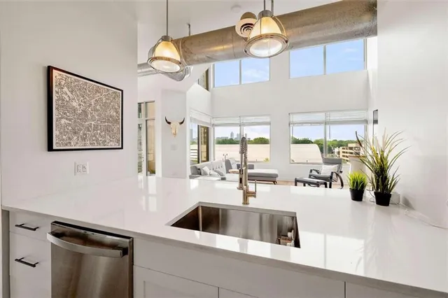 a kitchen with stainless steel appliances a stove microwave and refrigerator