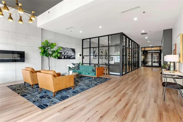 a living room with furniture and a floor to ceiling window