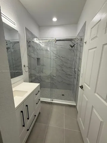 a bathroom with a shower toilet and sink