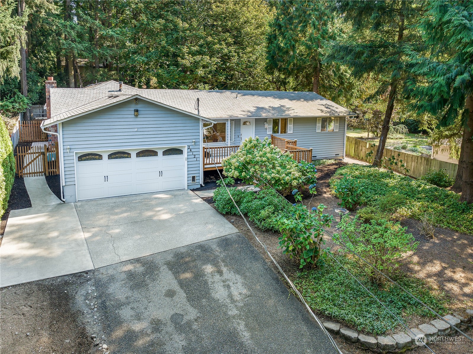 24121 6th Place West Bothell, WA 98021 - Photo 1 of 32 a view of a white house with a yard and potted plants