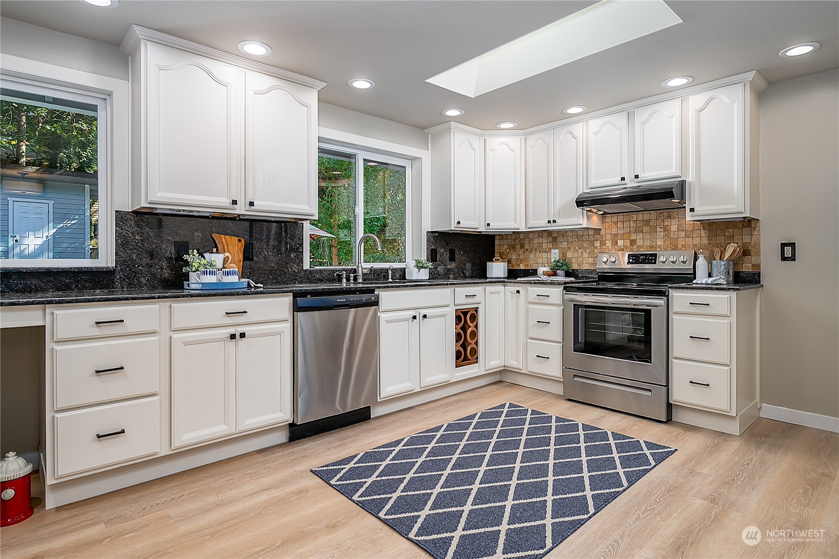 24121 6th Place West Bothell, WA 98021 - Photo 6 of 32 a kitchen with a stove sink and cabinets