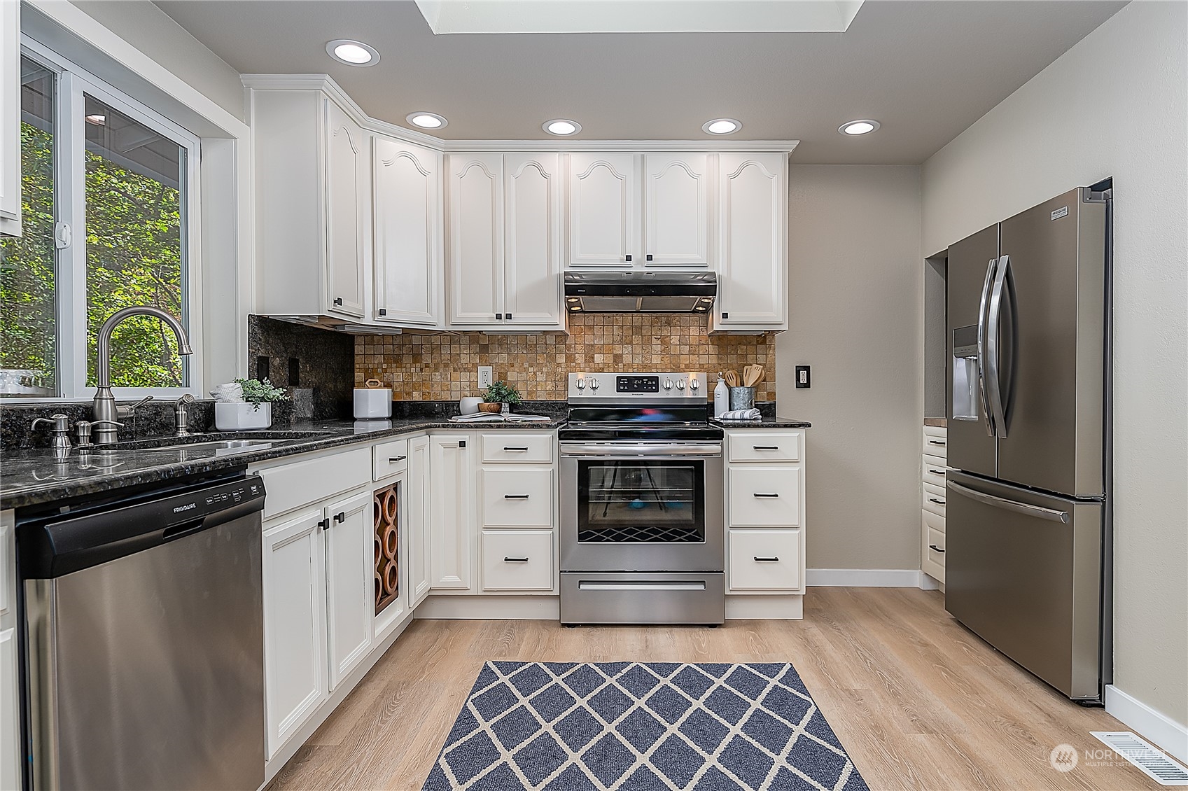 24121 6th Place West Bothell, WA 98021 - Photo 7 of 32 a kitchen with a refrigerator and a sink