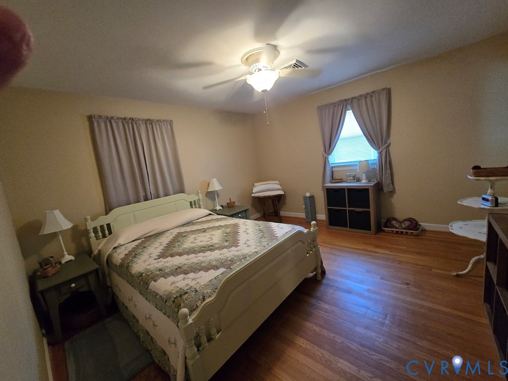 6 Mahan Road Farmville, VA 23901 - Photo 18 of 30 a spacious bedroom with a bed and a chandelier