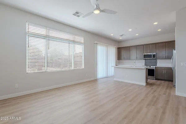 a view of kitchen with wooden floor and electronic appliances