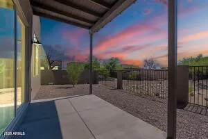 a view of a porch with a table and chairs