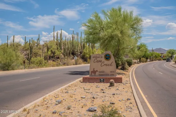a street sign on a sidewalk next to a road
