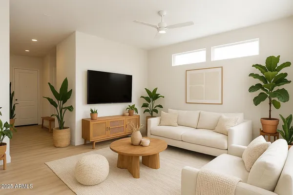 a living room with furniture a flat screen tv and a potted plant