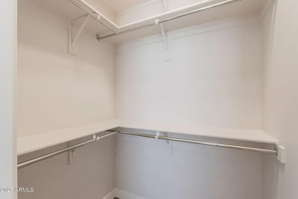 an empty room with wooden floor and closet