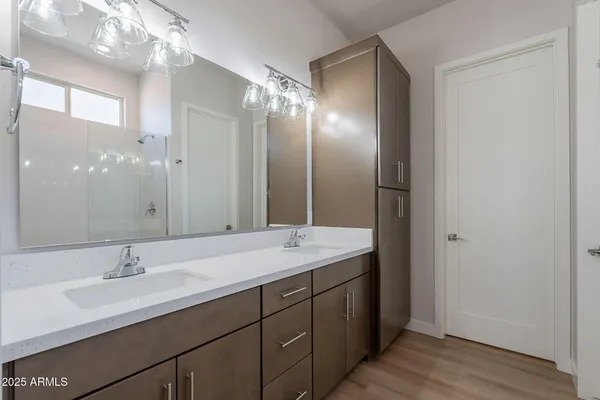 a view of kitchen with kitchen island wooden floor center island and stainless steel appliances