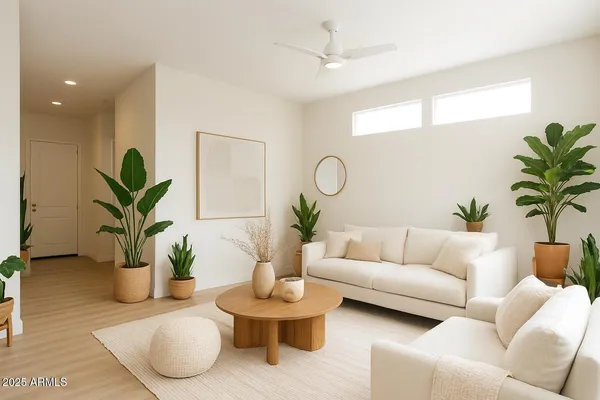 a living room with furniture potted plant and a window
