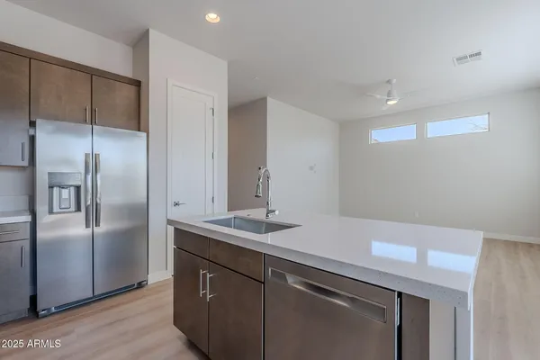 a kitchen with a refrigerator and a sink