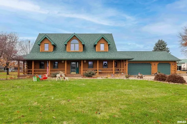 a view of a brick house with a yard