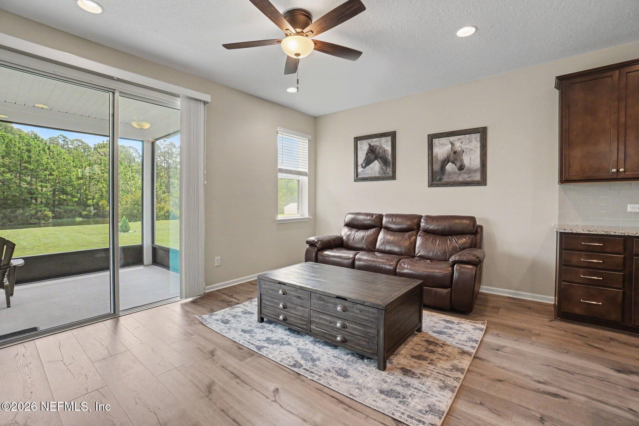 4630 Pine Ridge Parkway Middleburg, FL 32068 - Photo 7 of 35 a living room with furniture and a floor to ceiling window