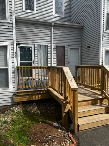 a view of deck with a chair and floor to ceiling window