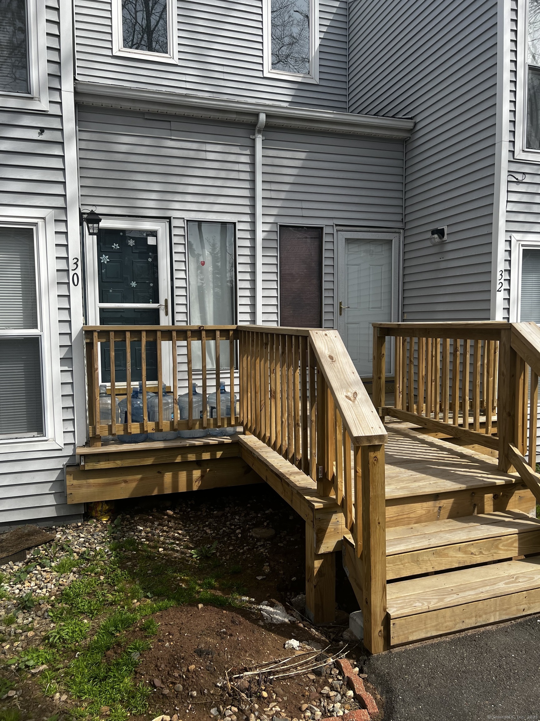 a view of deck with a chair and floor to ceiling window