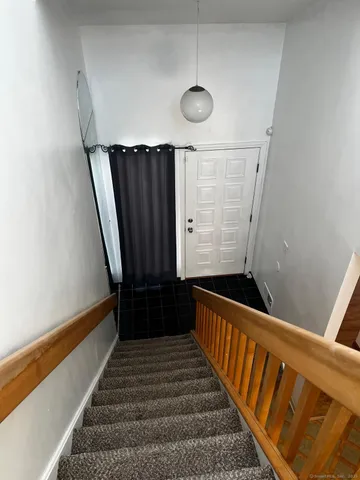 a view of balcony with wooden floor and stairs