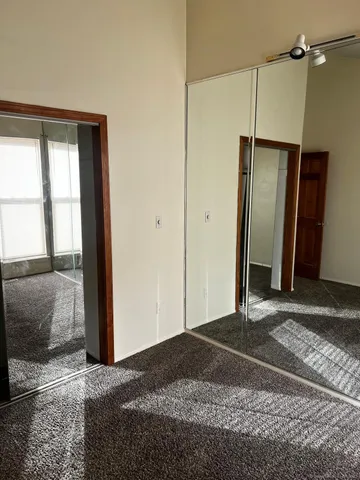 a bedroom with a bed and a mirror