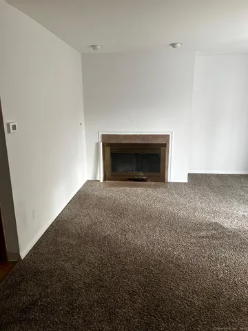 a view of empty room with a fireplace