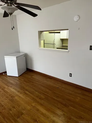 a view of a room with wooden floor and cabinet