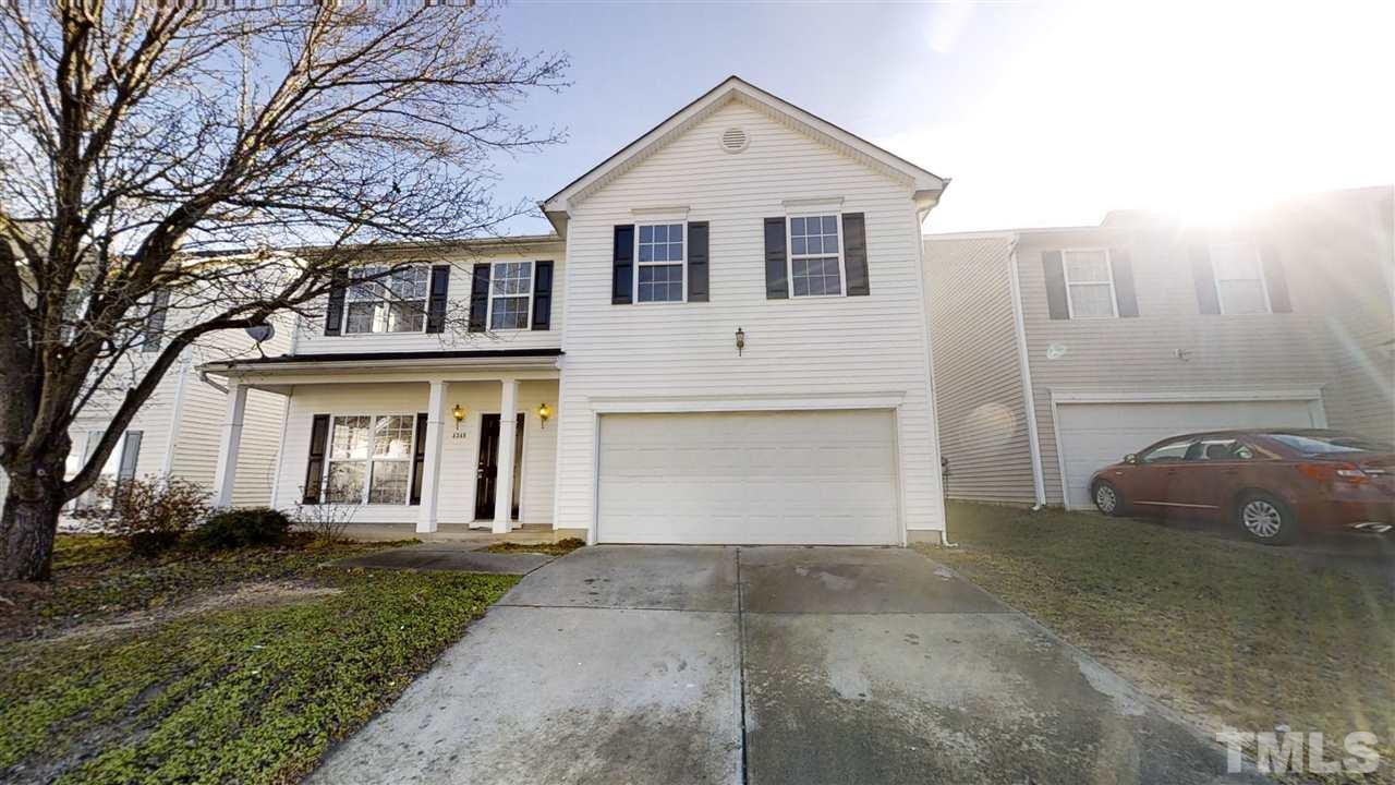 4348 Cardinal Grove Boulevard Raleigh, NC 27616 - Photo 2 of 30 a view of a white house with a large windows and a yard
