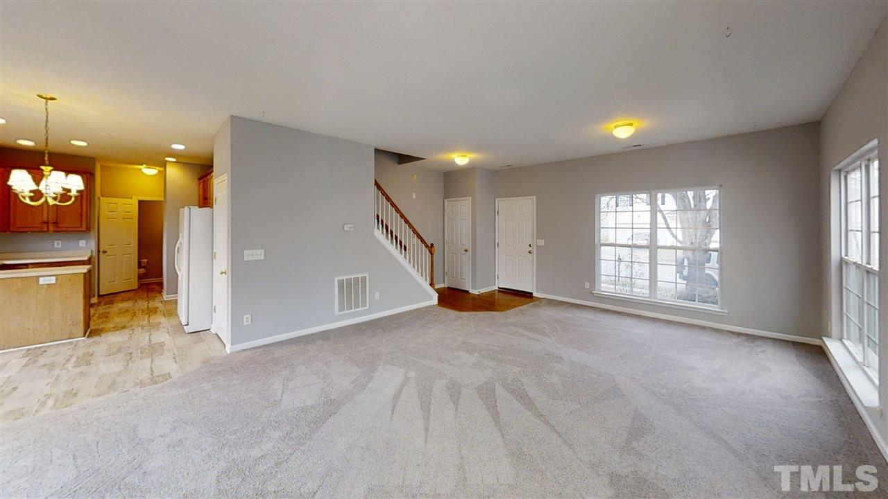4348 Cardinal Grove Boulevard Raleigh, NC 27616 - Photo 11 of 30 an empty room with windows and fireplace