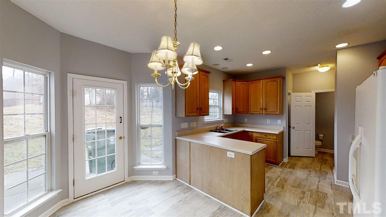 4348 Cardinal Grove Boulevard Raleigh, NC 27616 - Photo 12 of 30 a kitchen with stainless steel appliances granite countertop a stove and a refrigerator