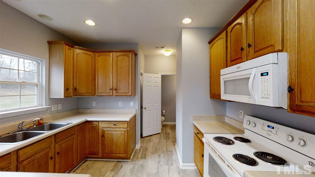 4348 Cardinal Grove Boulevard Raleigh, NC 27616 - Photo 13 of 30 a kitchen with stainless steel appliances granite countertop a sink a stove and a refrigerator