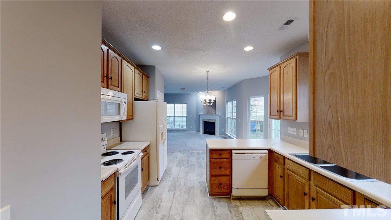 4348 Cardinal Grove Boulevard Raleigh, NC 27616 - Photo 14 of 30 a kitchen with stainless steel appliances granite countertop a stove and a sink